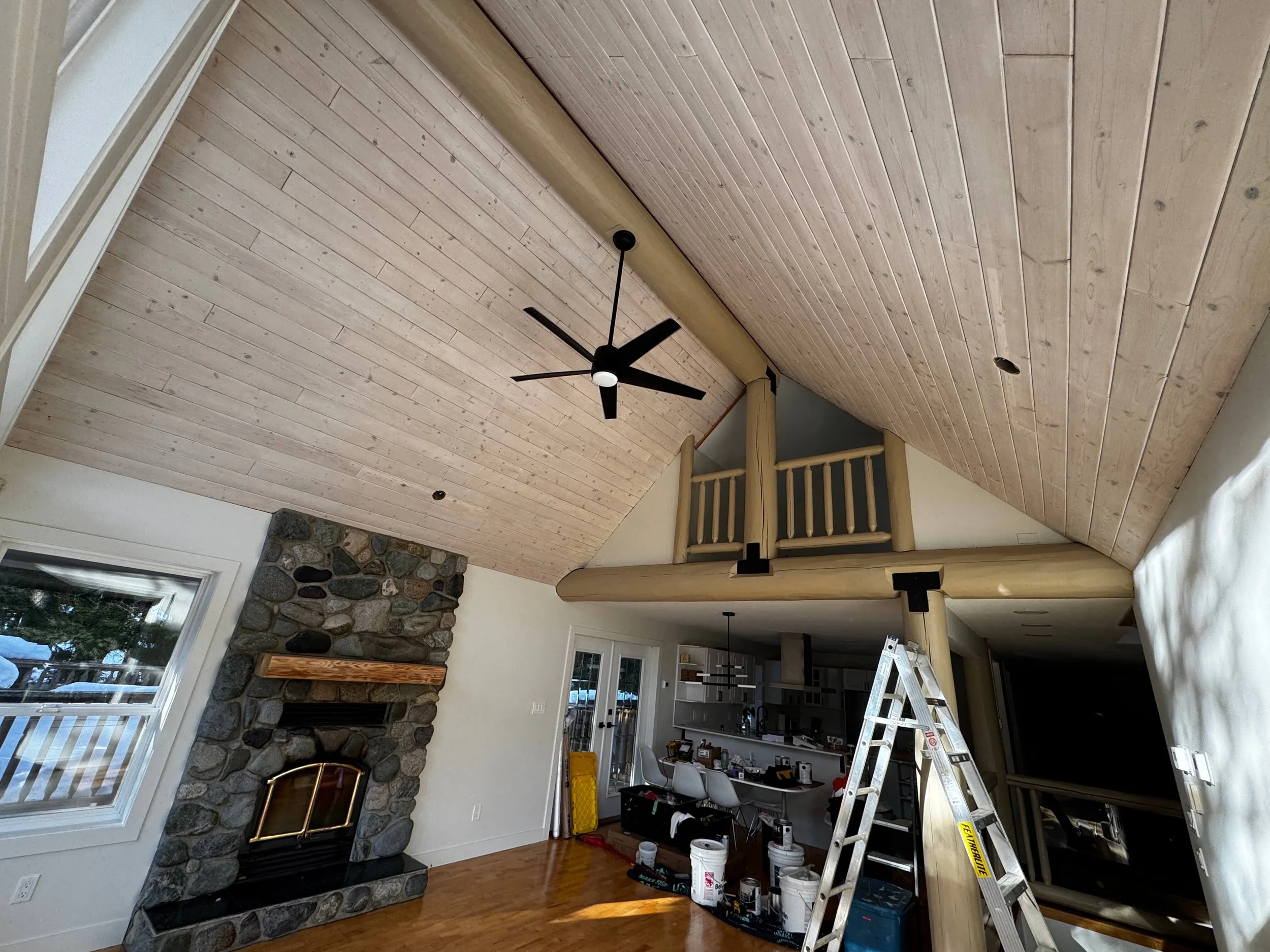 Whistler living room with stone fireplace, wood accents, and organic modern furnishings