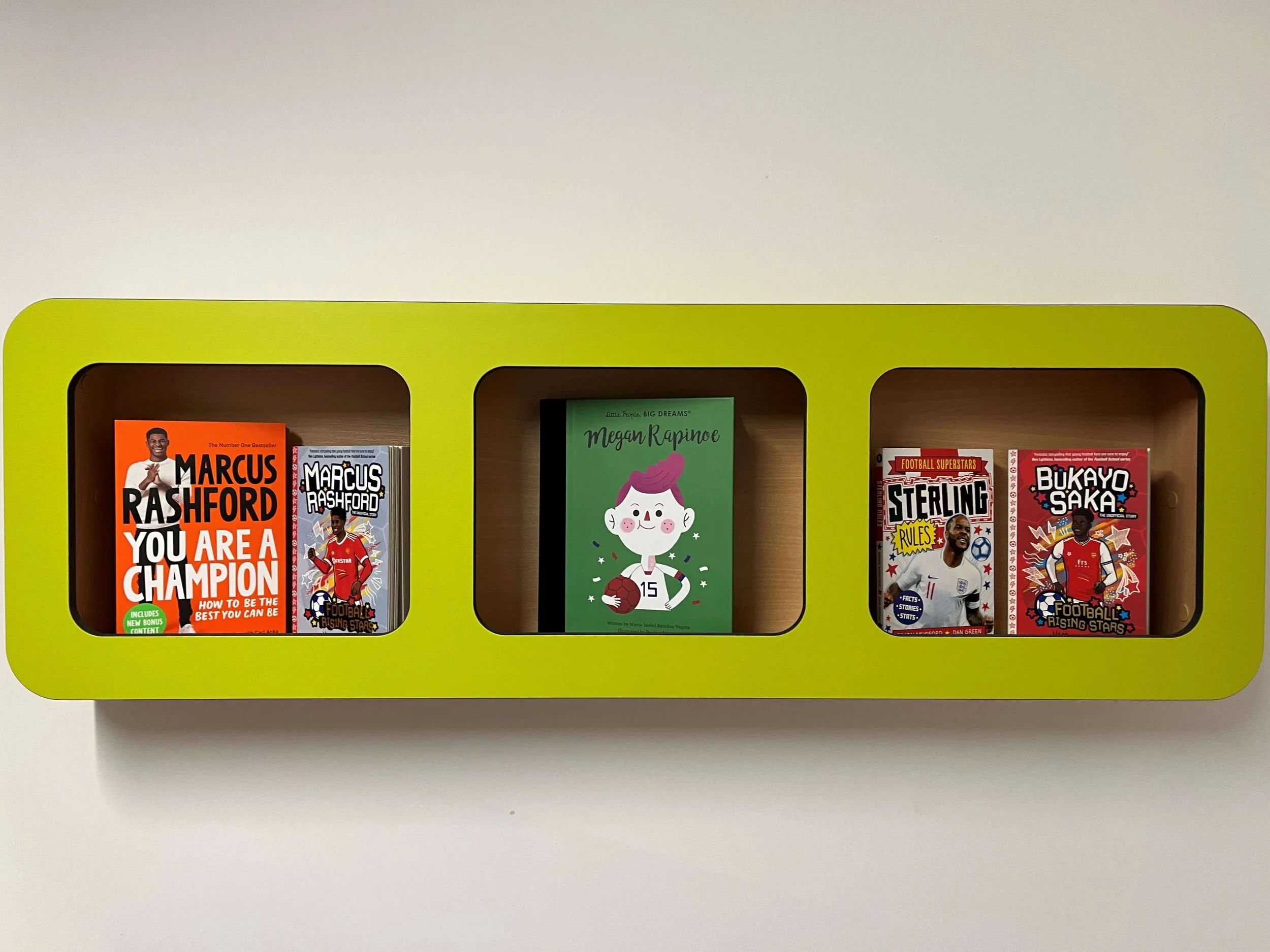 Wall mounted display in new school library. Go All In with books children love. Football books displayed in school library. 