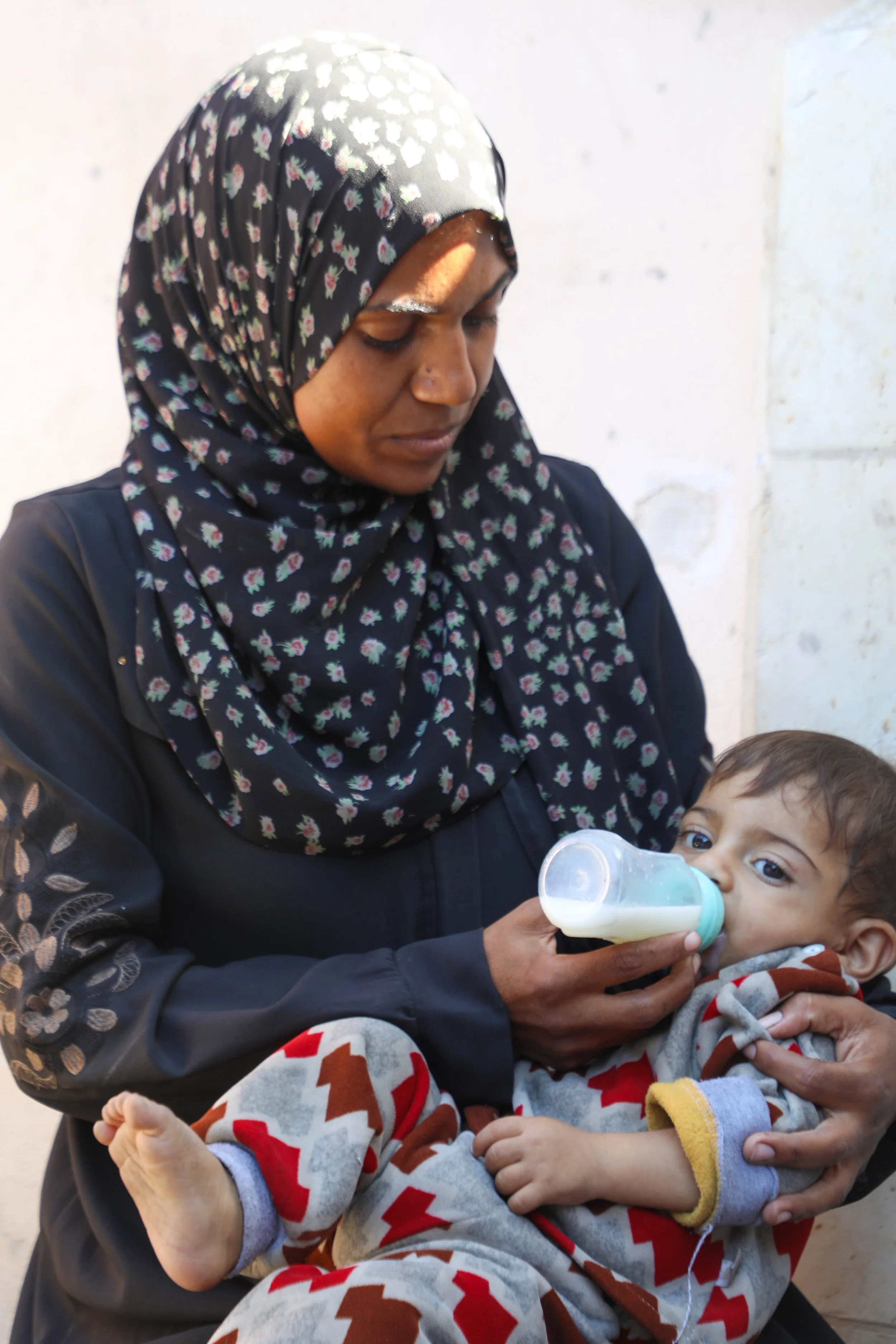 mother feeding milk baby in gaza.JPG
