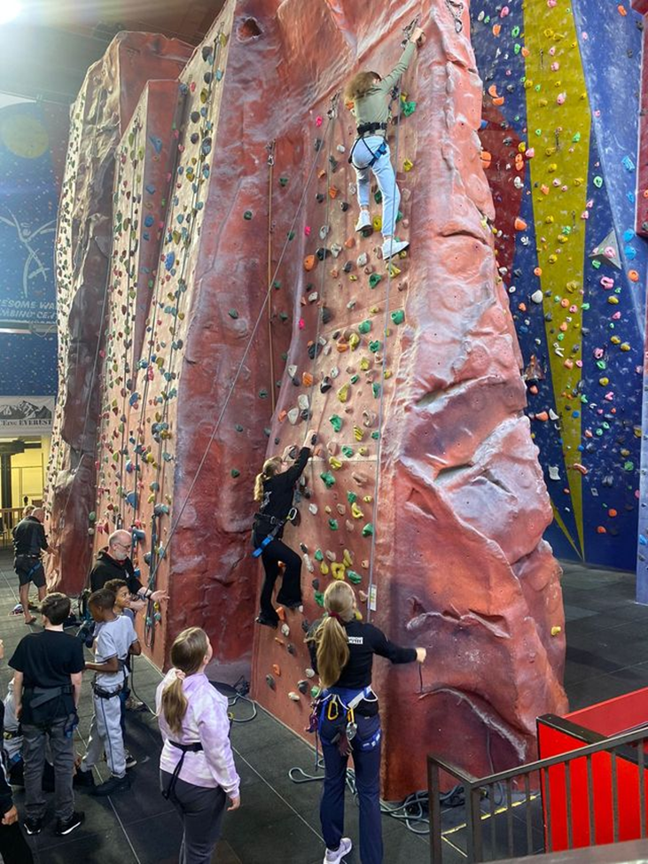 Adsbridge Youth Connection participants scaling an indoor climbing wall