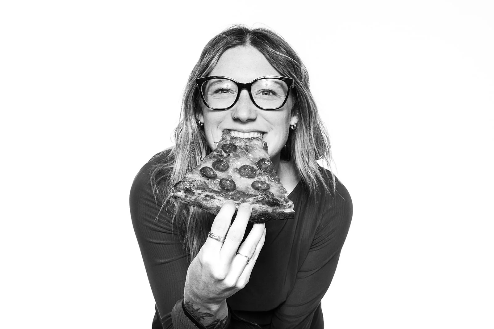 Elizah smiles with pizza