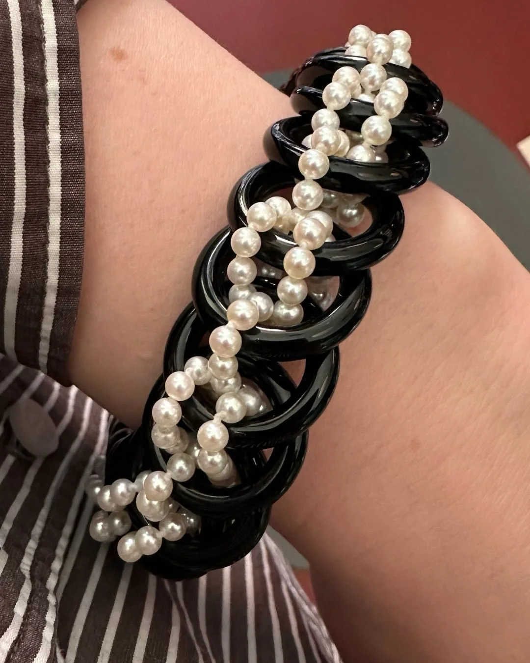 Up close and personal with the new Eclipse collection by @melaniegeorgacopoulos, which presents pearls in totally new ways: wrapped through custom-cut onyx links, or peeking out of heavy silver designs cast from a single piece of metal.