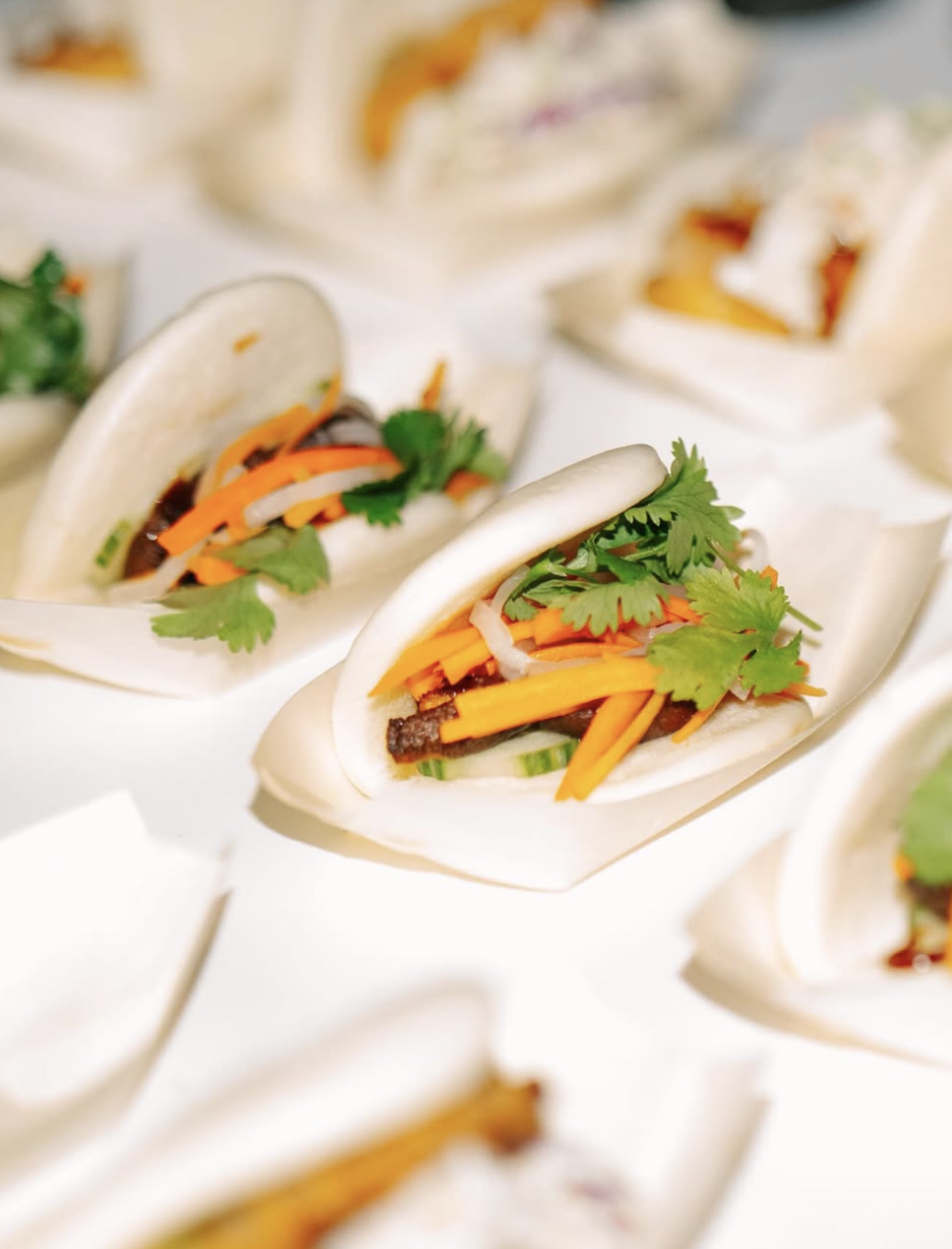 Artful display of gourmet bao buns, styled for an elegant wedding reception.