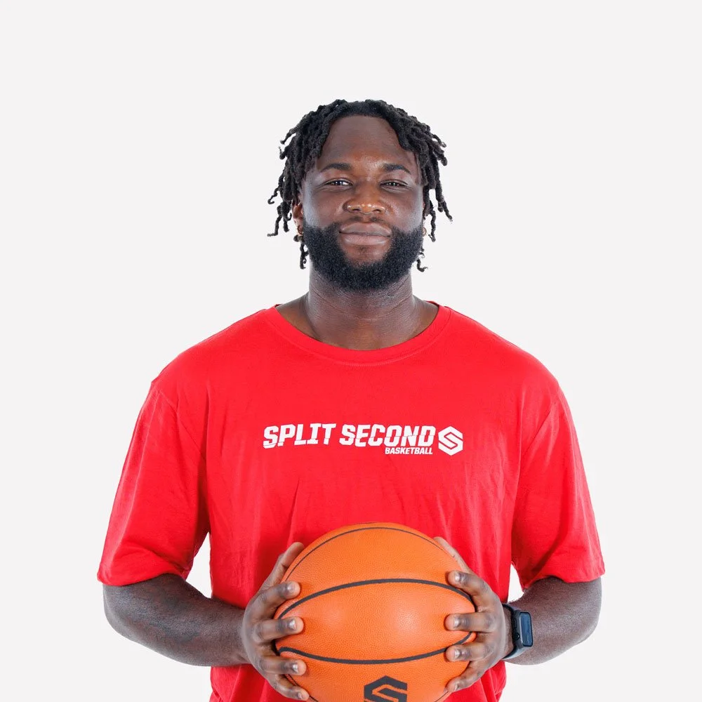 Jeremiah Kabia in a red Split Second Basketball shirt holding a basketball