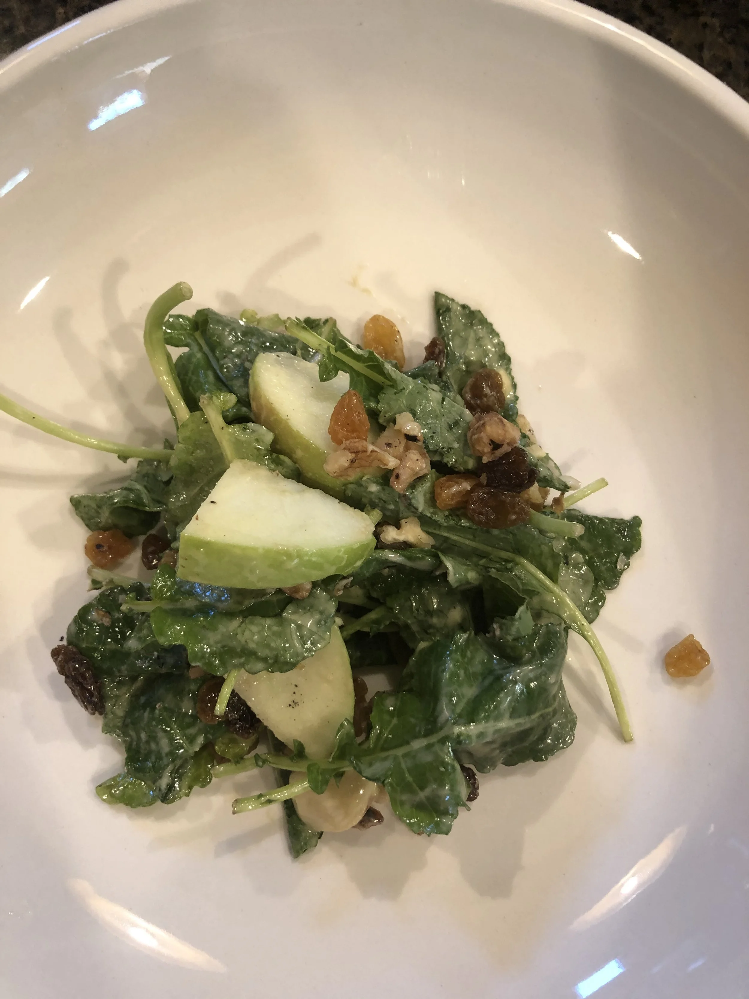 Kale Salad with Apple Cider Vinaigrette with Fresh Apple, Dried Fruit, Sunflower Seeds and Soft Cheese