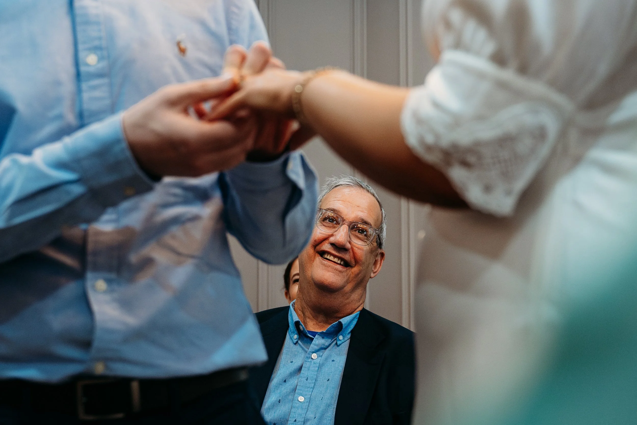 Proud dad looking at ring exchange during courthouse wedding Limerick city