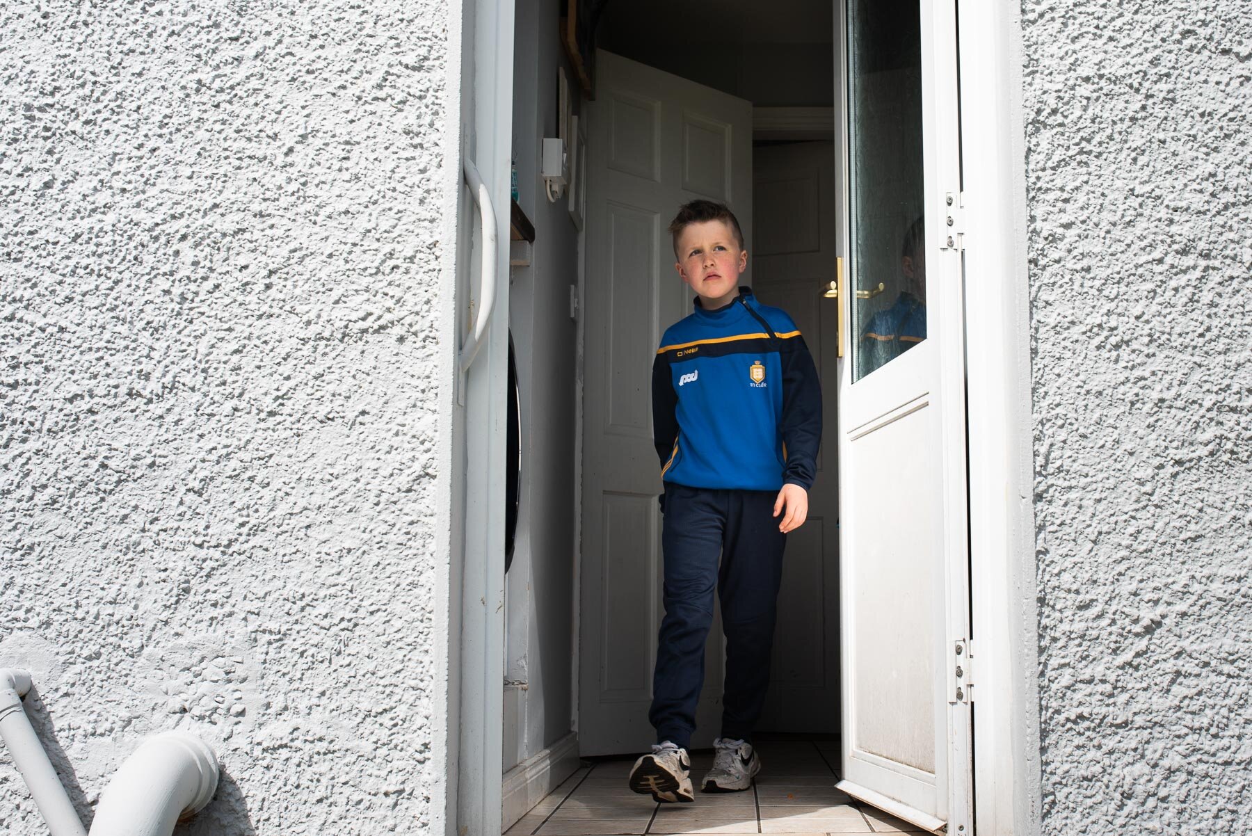 boy coming out of door to back garden