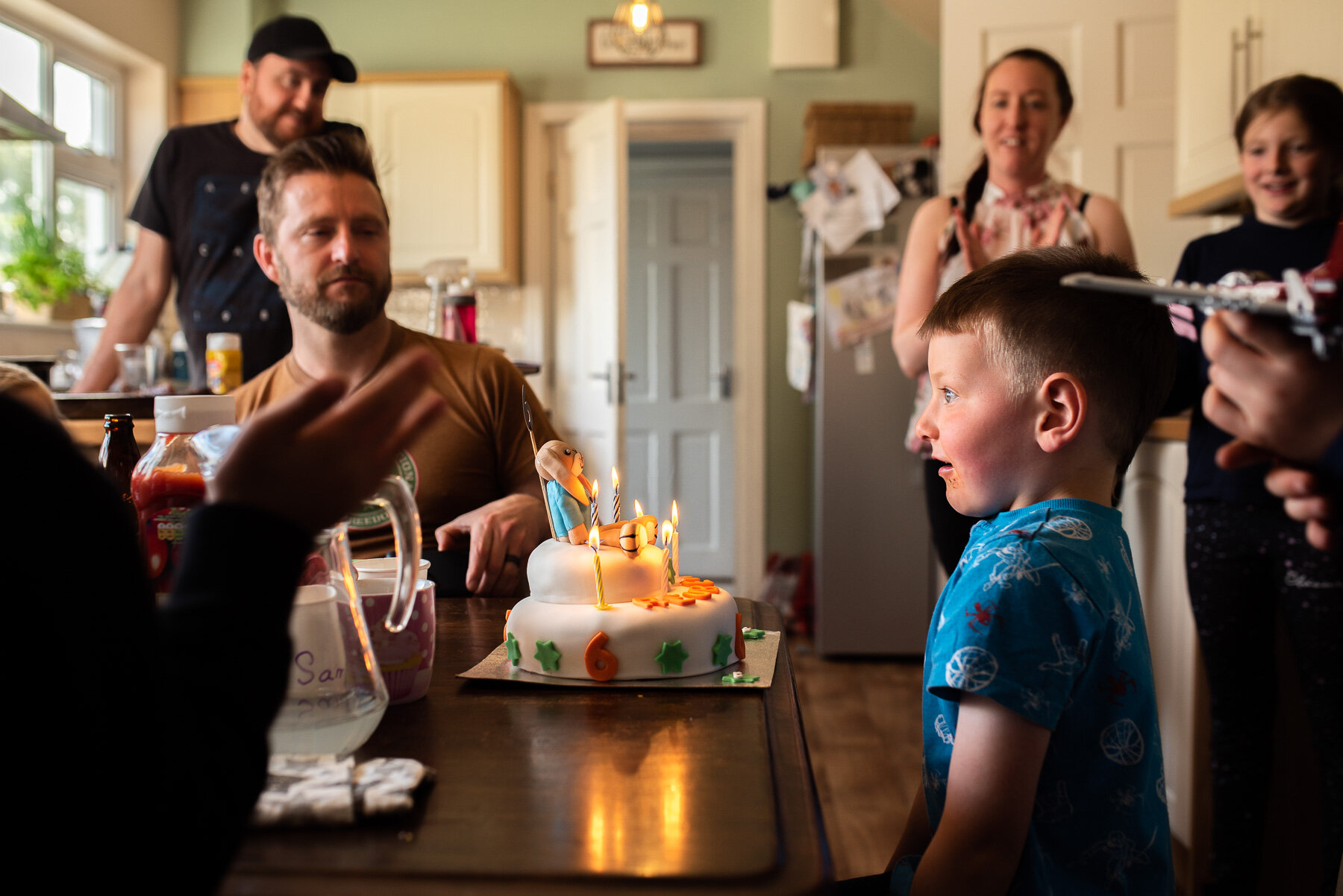 boy smiling at birthday cake