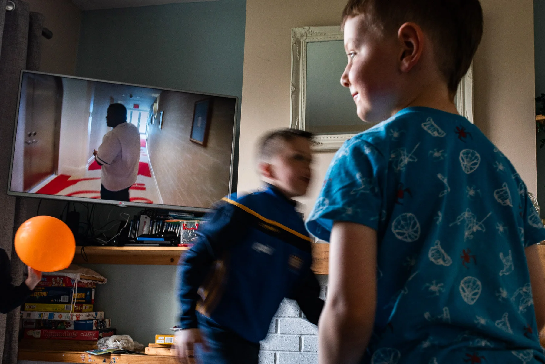 boys playing with balloons in the front living room