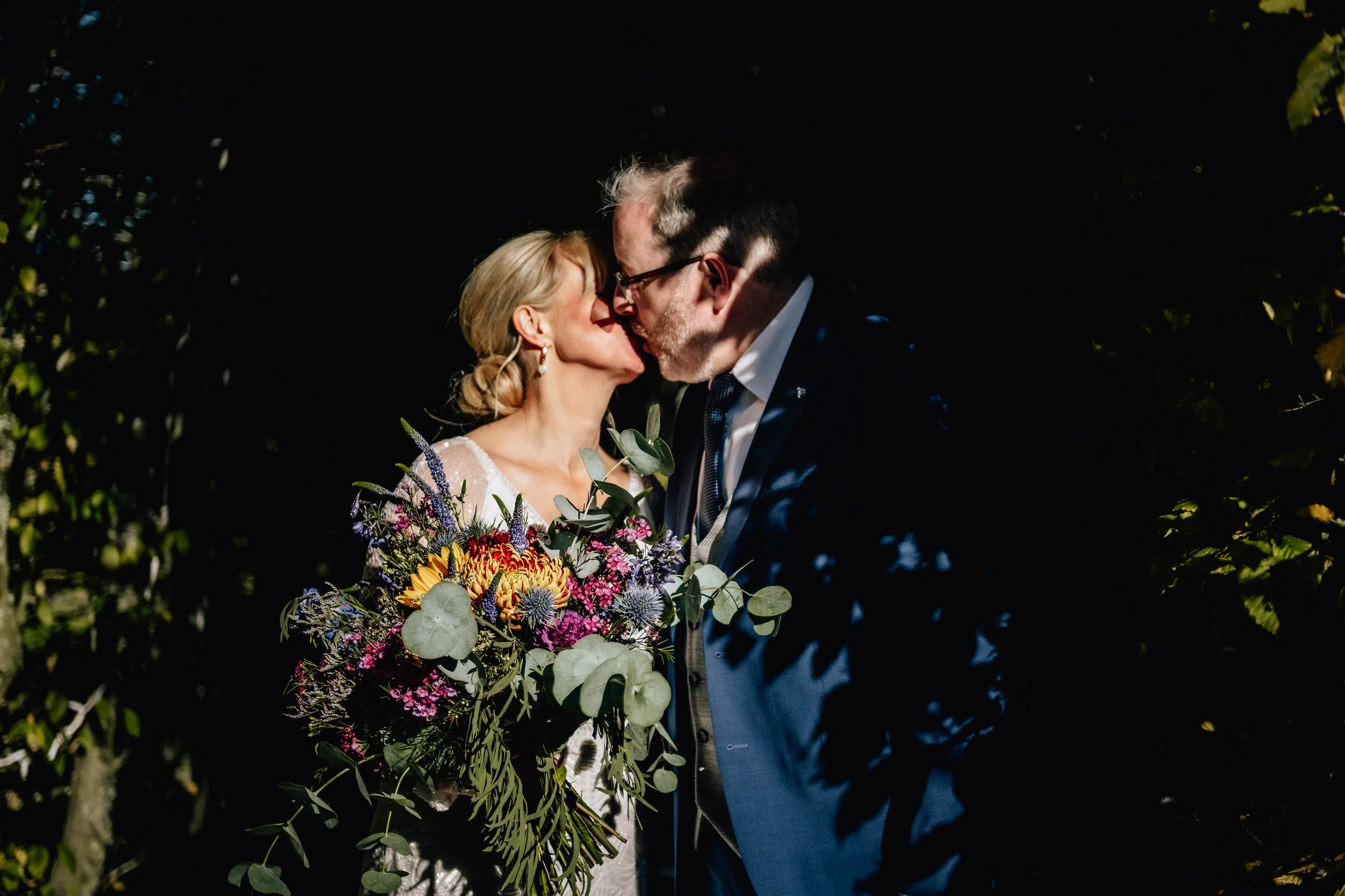 bride and groom kissing in harsh light shadow Dromoland wedding Limerick wedding photographer
