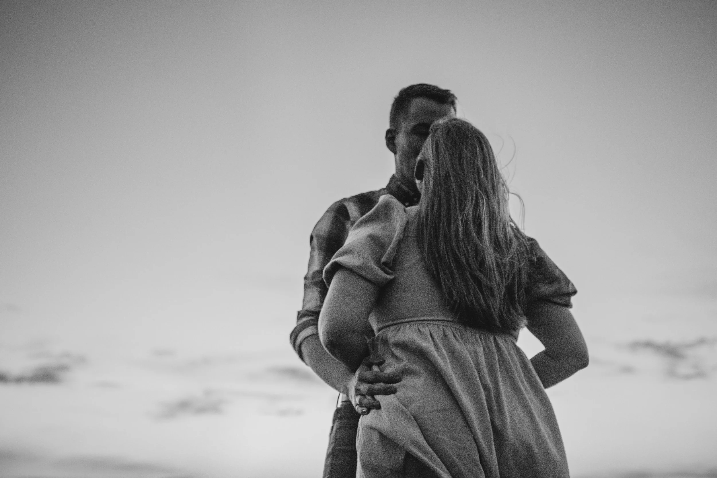 Couples session cliffs of moher at sunset with couple standing against the sky