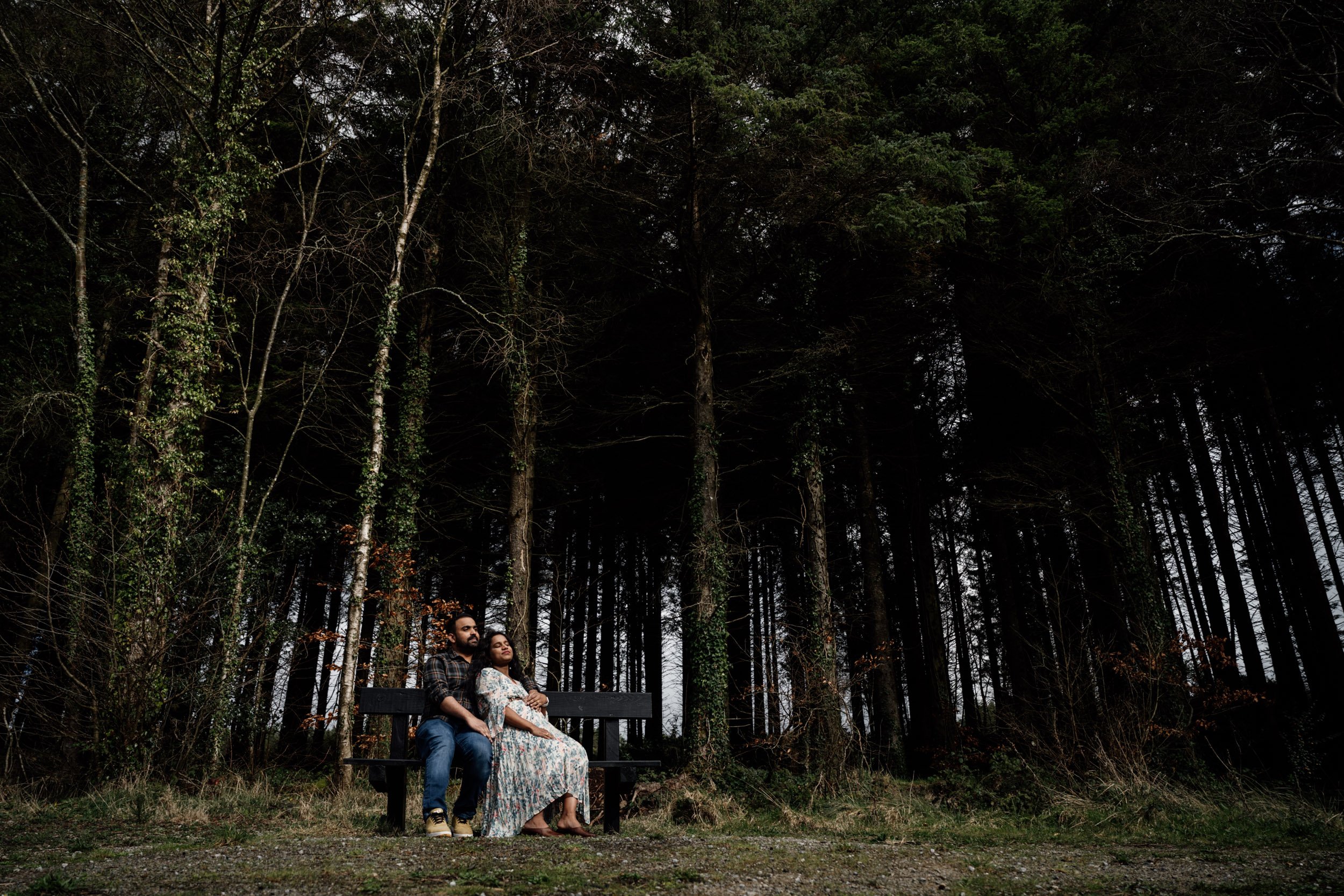 trees and couple on benchrainy maternity shoot cratloe woods ireland maternity photographer ireland