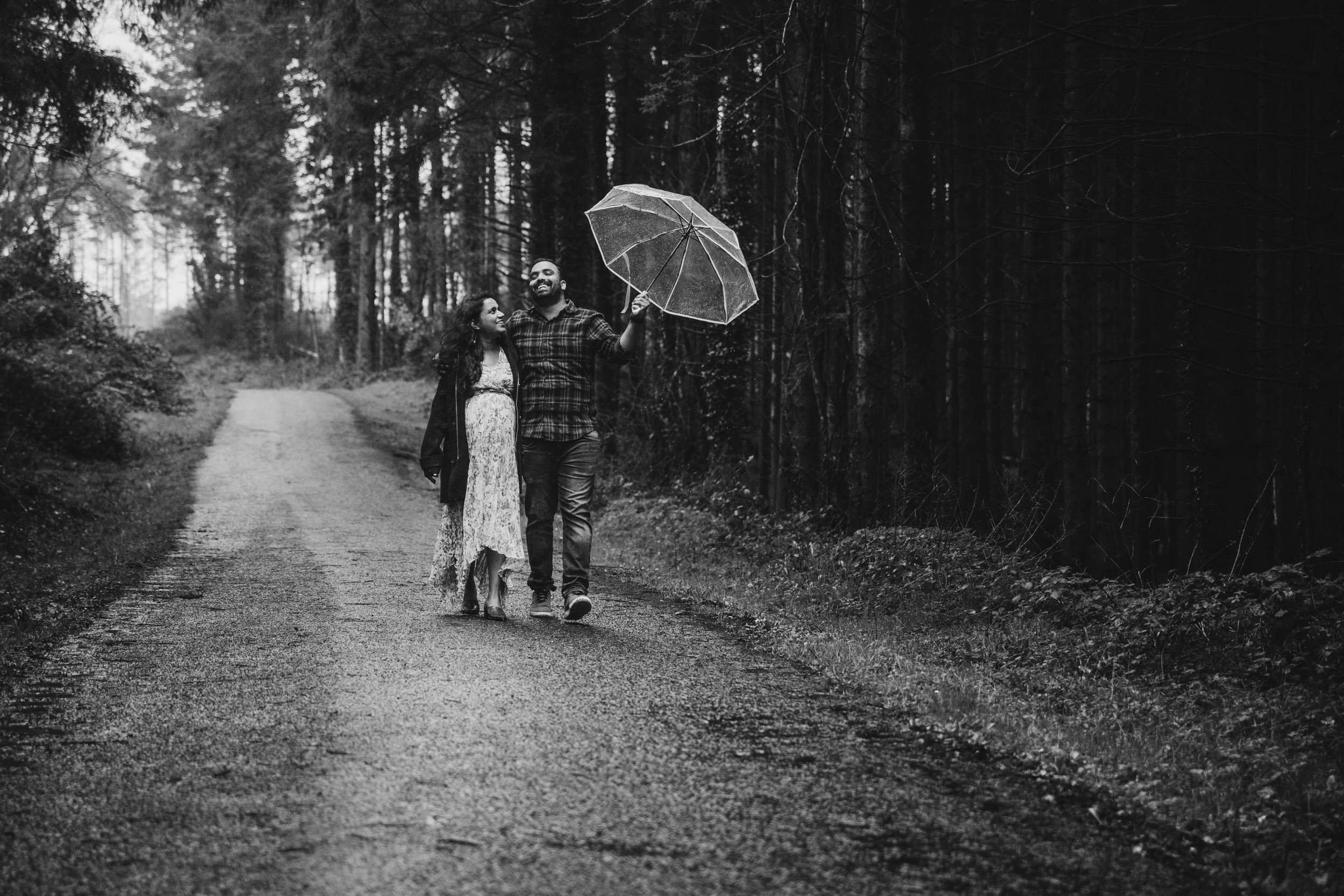 rainy day Husband laughing black and white cratloe woods maternity photos Ireland
