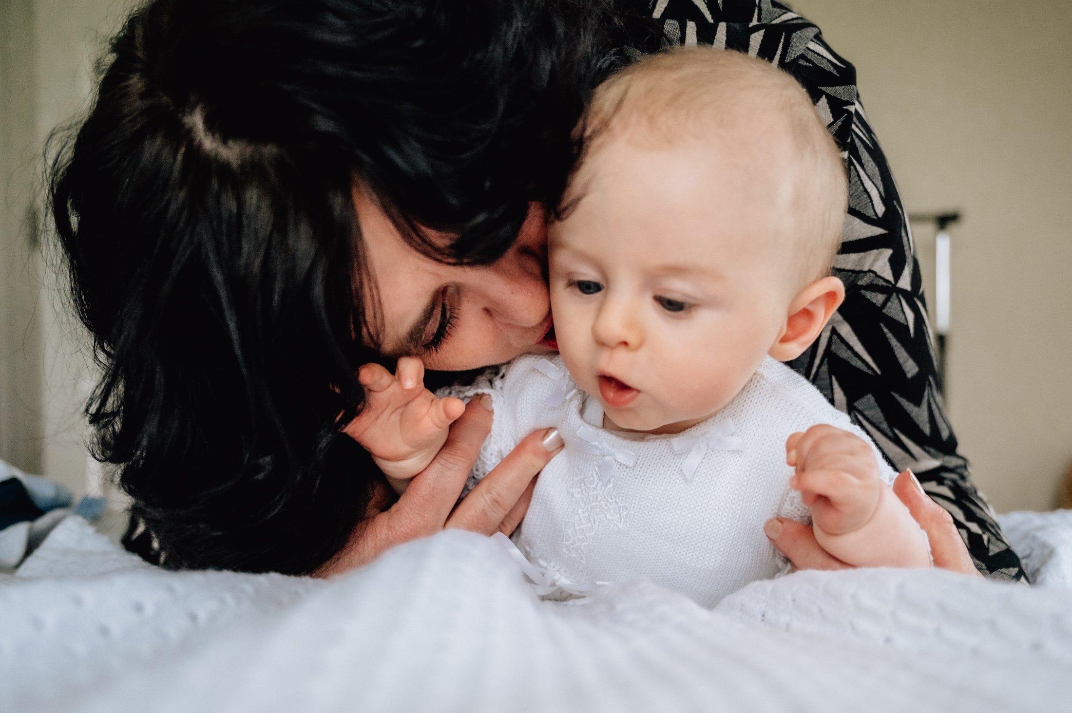 grandma kissing baby boys cheek in home family photos for christening photos limerick photographer