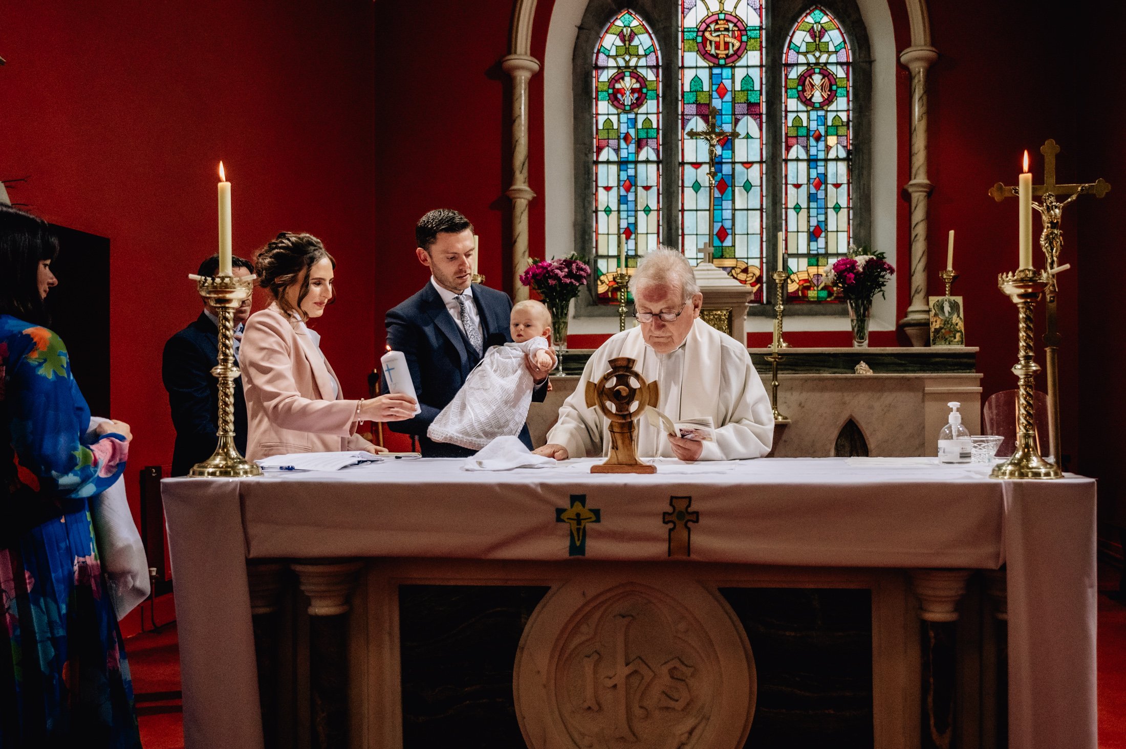 family and priest at alter christening photos limerick photographer