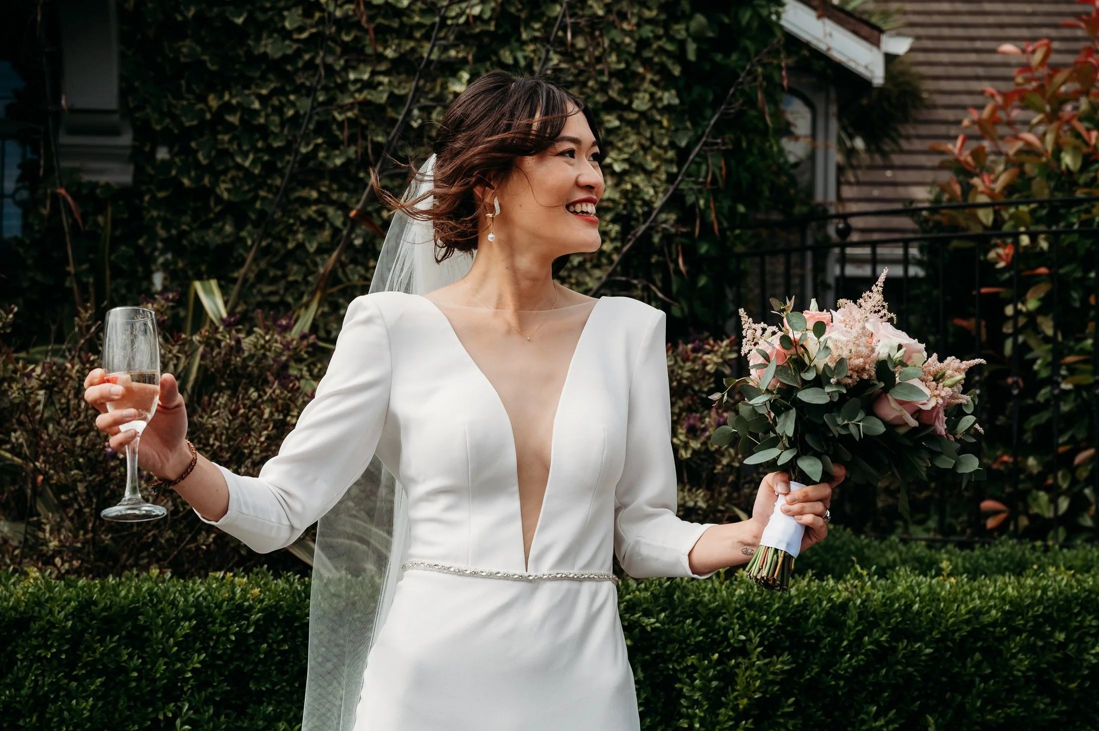 bride with flowers and champagne at Oakwood Arms Hotel wedding venue