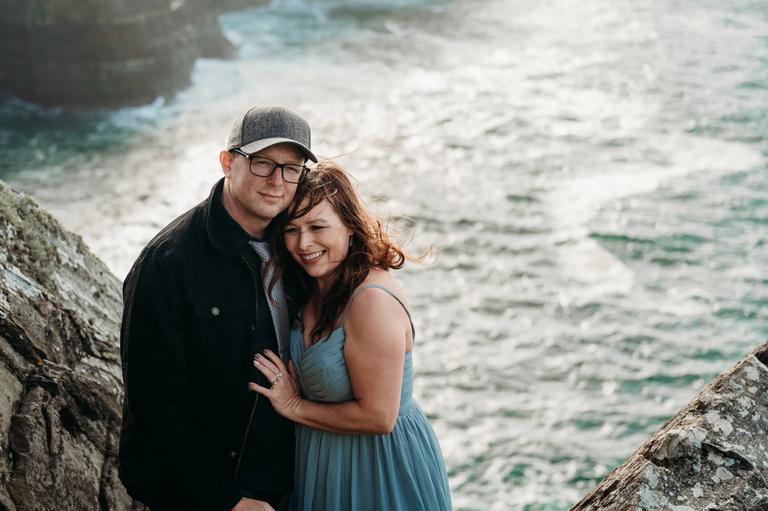Marie O'Mahony photographer Cliffs of Moher anniversary couples photo session cuddling with water in background