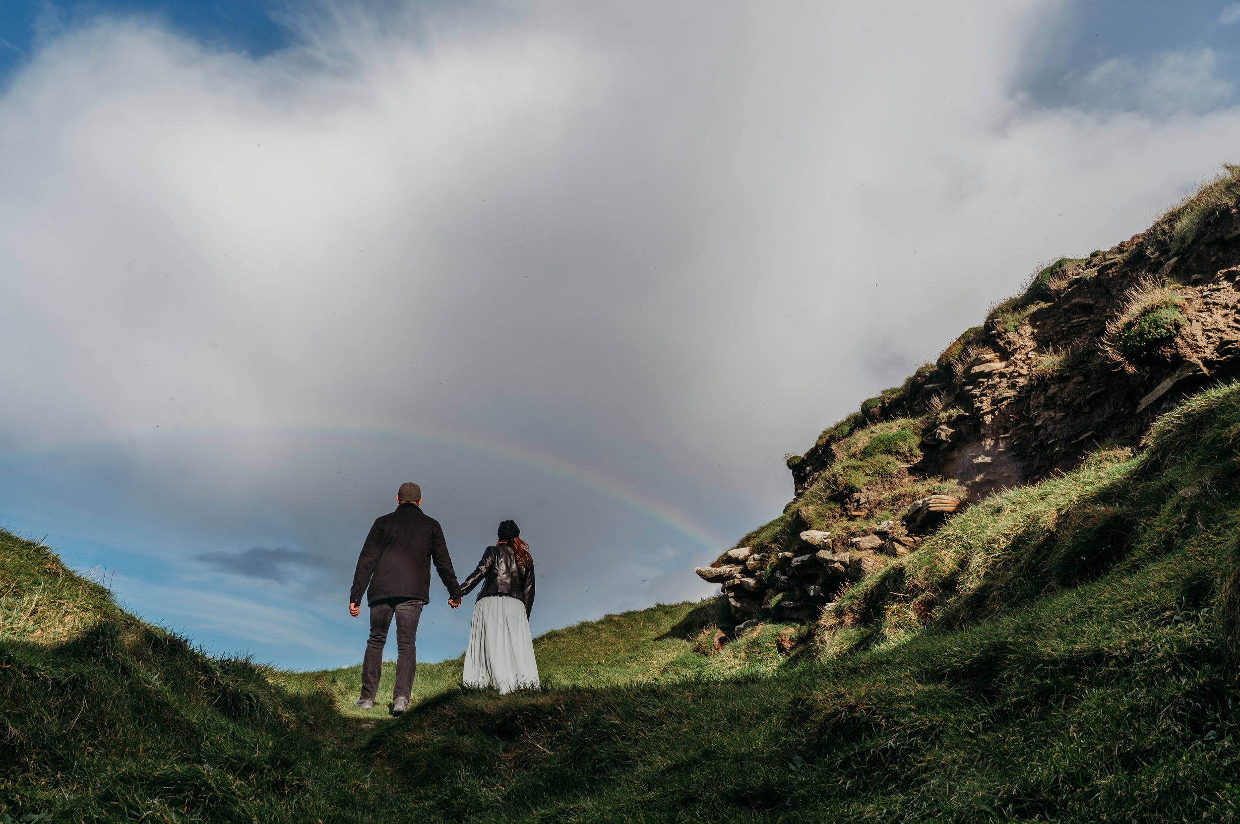 Marie O'Mahony photographer Cliffs of Moher anniversary couples photo session walking under the rainbow
