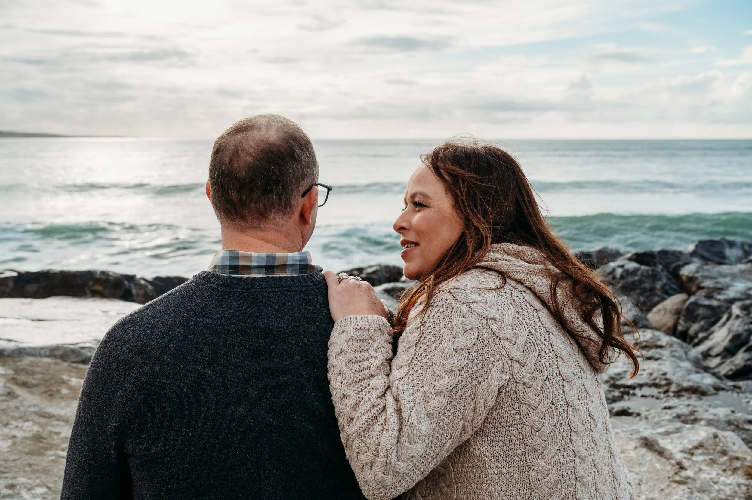 Marie O'Mahony photographer Lahinch anniversary couples photo session sitting on rocks