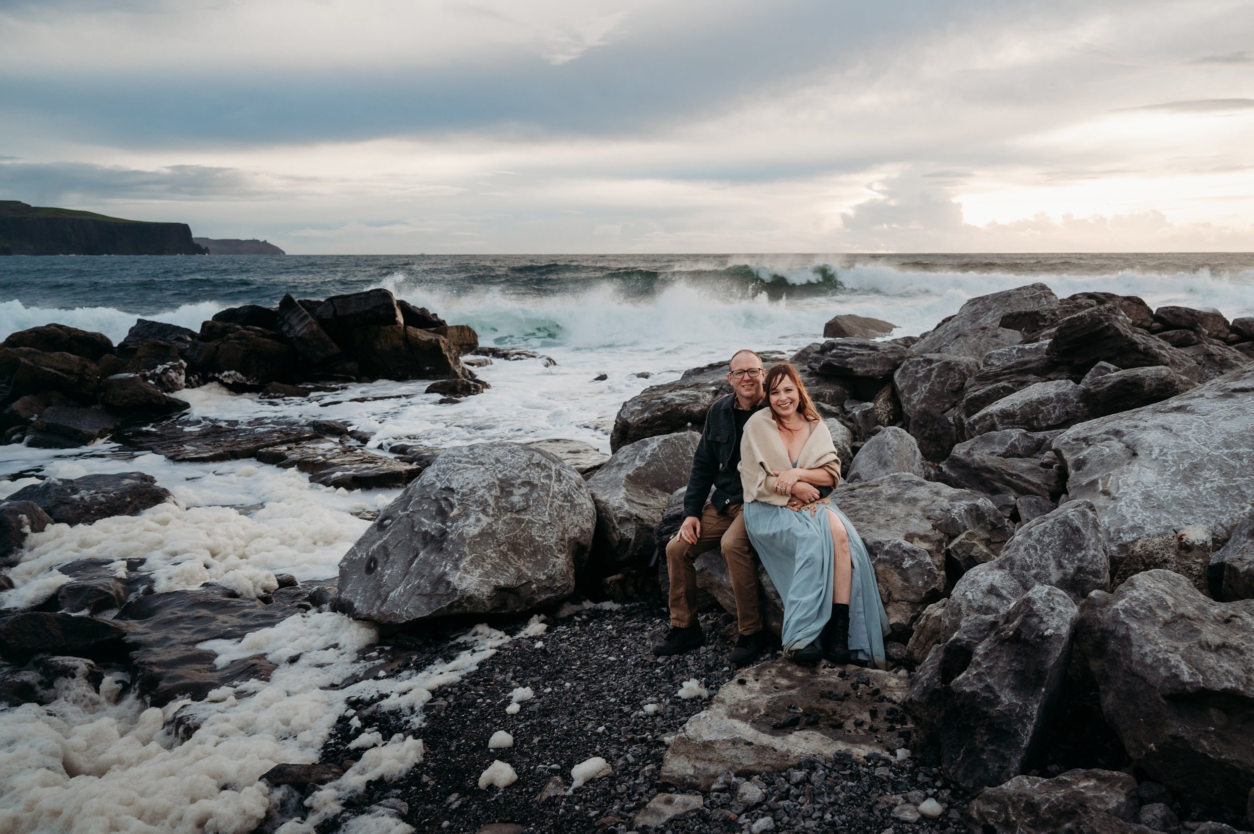 Marie O'Mahony photographer Doolin pier anniversary couples photo session sitting near the waves