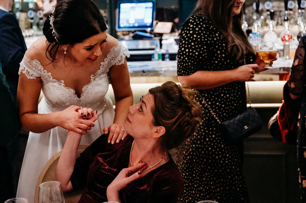 Bride talking to a woman during dinner