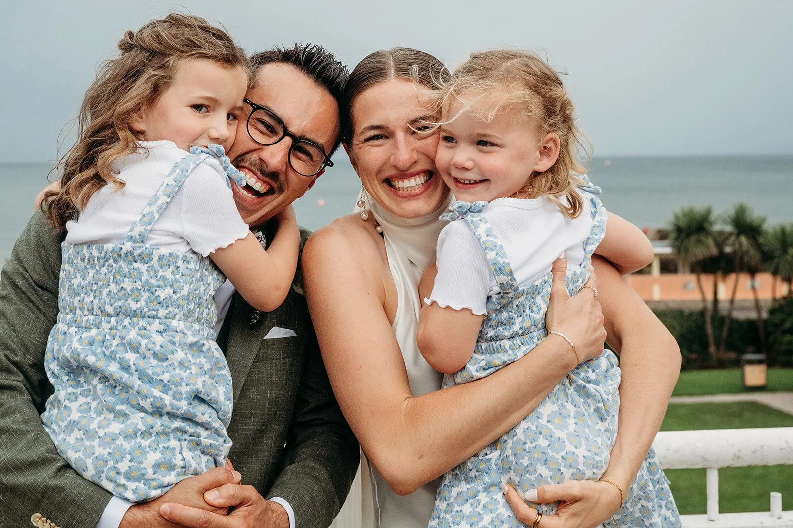 Galway Bay Hotel wedding photos bride and groom cuddling little girls in blue