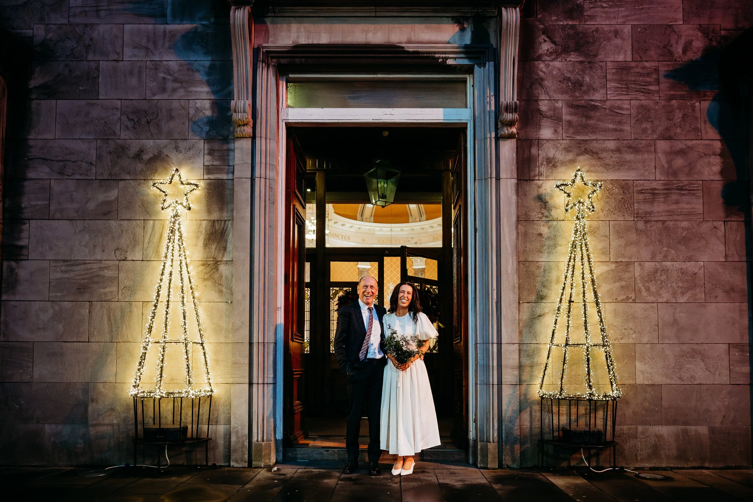 Wedding photo St Joseph's church Limerick city bride and father at church door Christmas lights