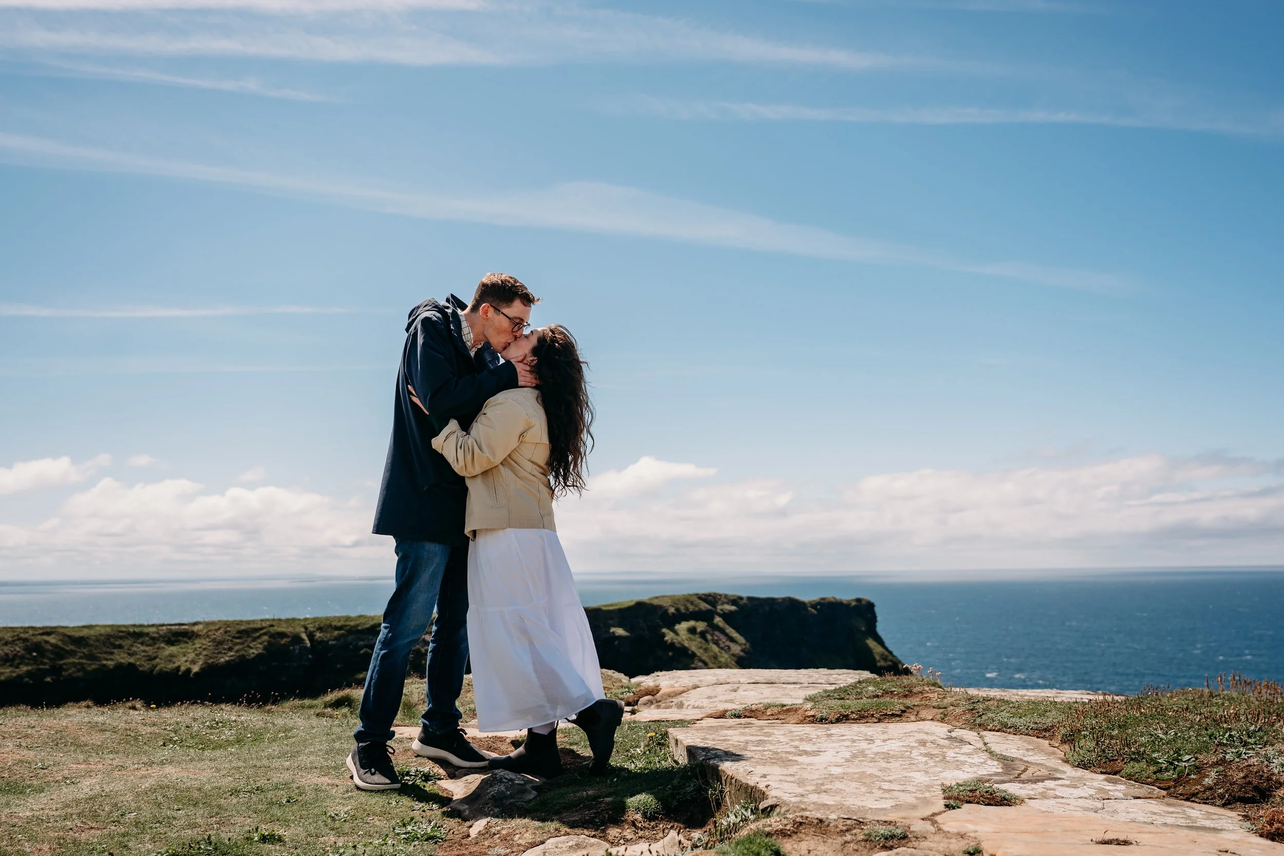 kissing on the top of the cliffs of mother on a sunny day