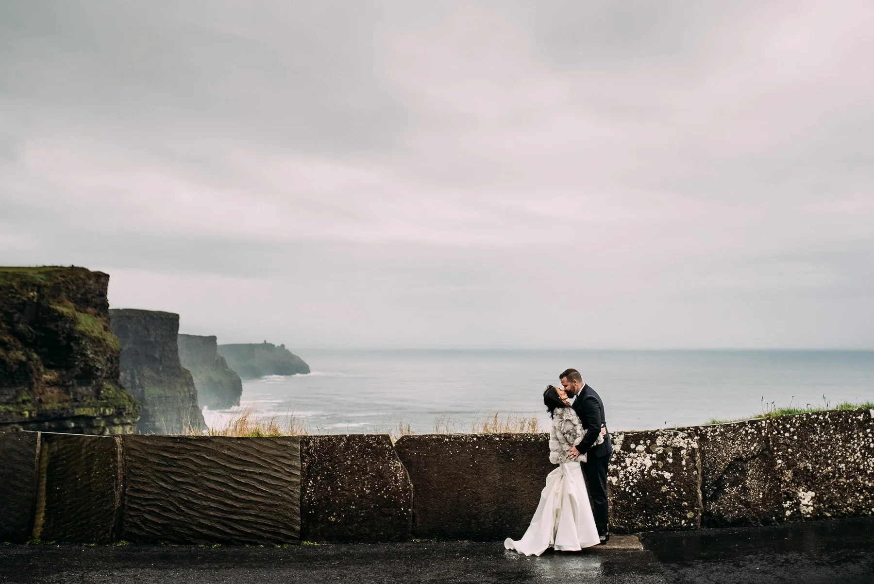 couple kissing cliffs of moher kilyn wedding.jpg