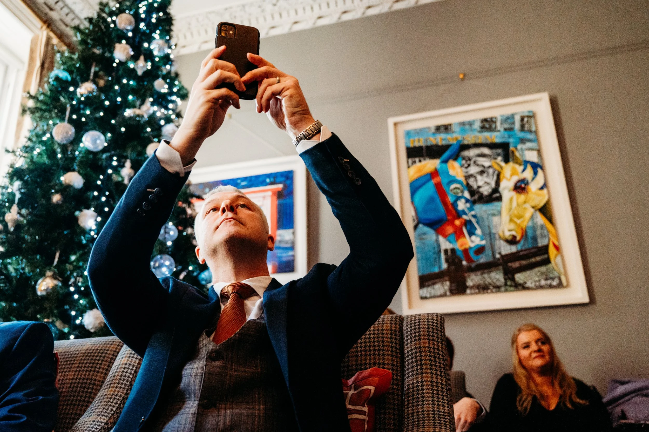 guest at wedding ceremony taking a phone picture no 1 Pery Square wedding photos Limerick photographer Marie O'Mahony