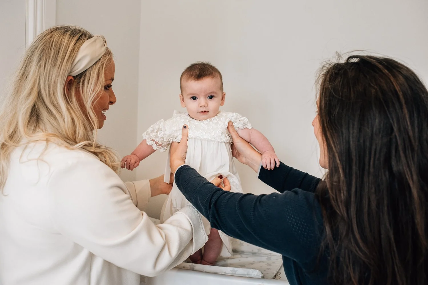 Christening baby getting dressed.jpg