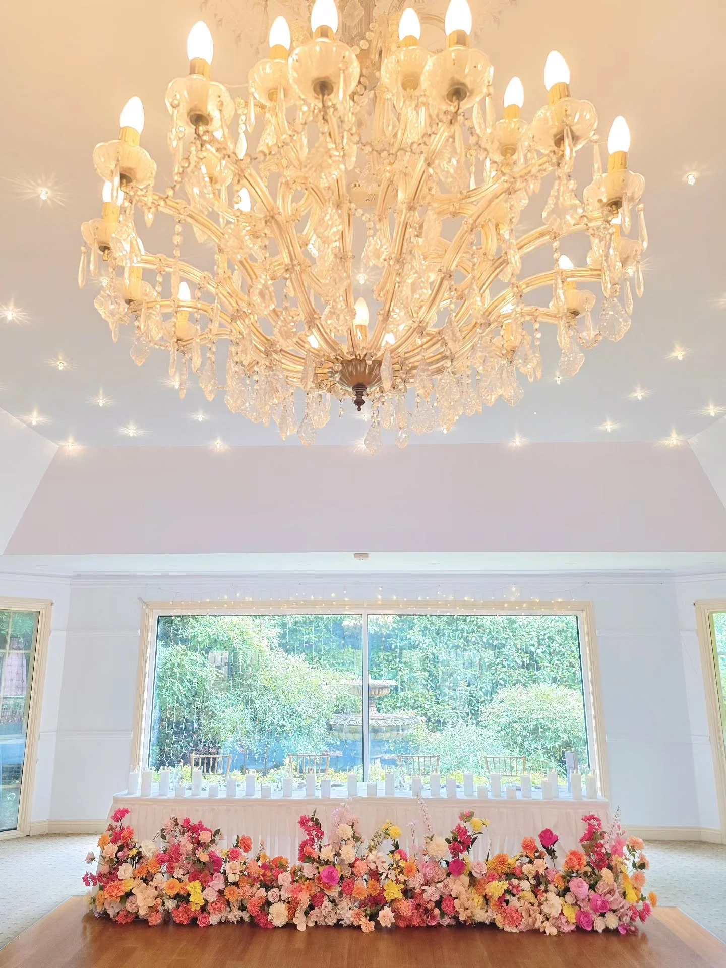 ✨ A Burst of Colour &amp; Romance ✨
Transforming the reception space with bold, joyful florals in shades of coral, yellow, hot pink and peach &mdash; the perfect blend of fun and elegance.

From the tall centrepieces to the lush bridal table garden, 