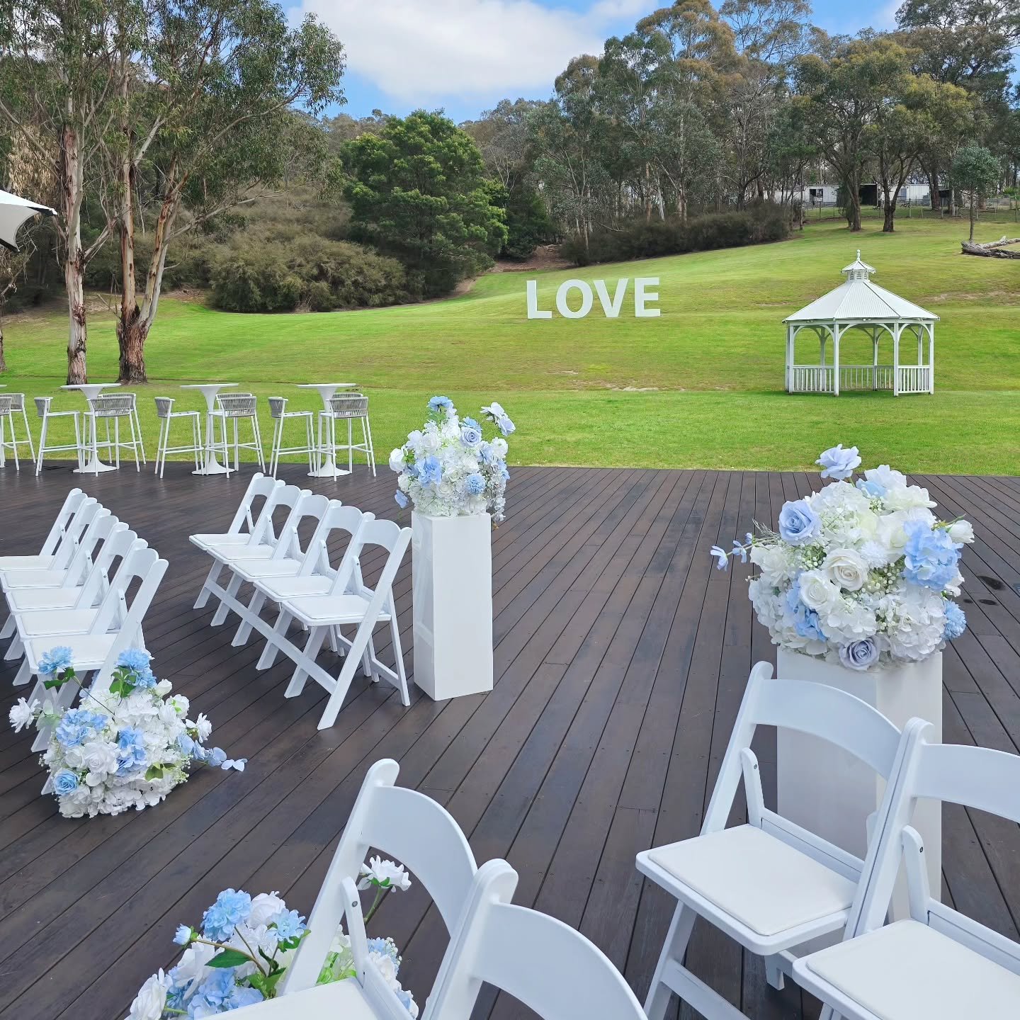 A beautiful ceremony entry at Bramleigh Estate under a clear blue sky 💙

Soft blue and white florals welcoming guests as they arrive, paired with crisp white chairs and open countryside views &mdash; Set against rolling green hills and that iconic L