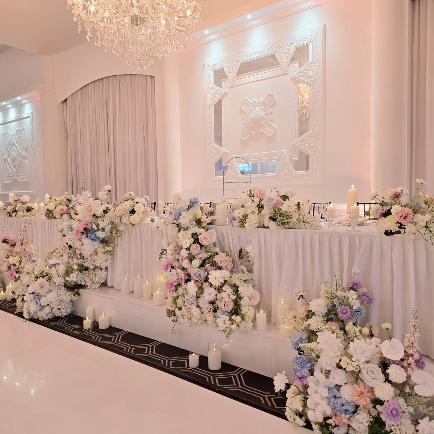 Celebrating a 25th wedding anniversary @vogueballroom

Pastel dreams in bloom 🌸
Our cascading asymmetric bridal table florals flow into a seamless dance floor design, perfectly paired with matching tall centrepieces for a cohesive, elevated look.

S