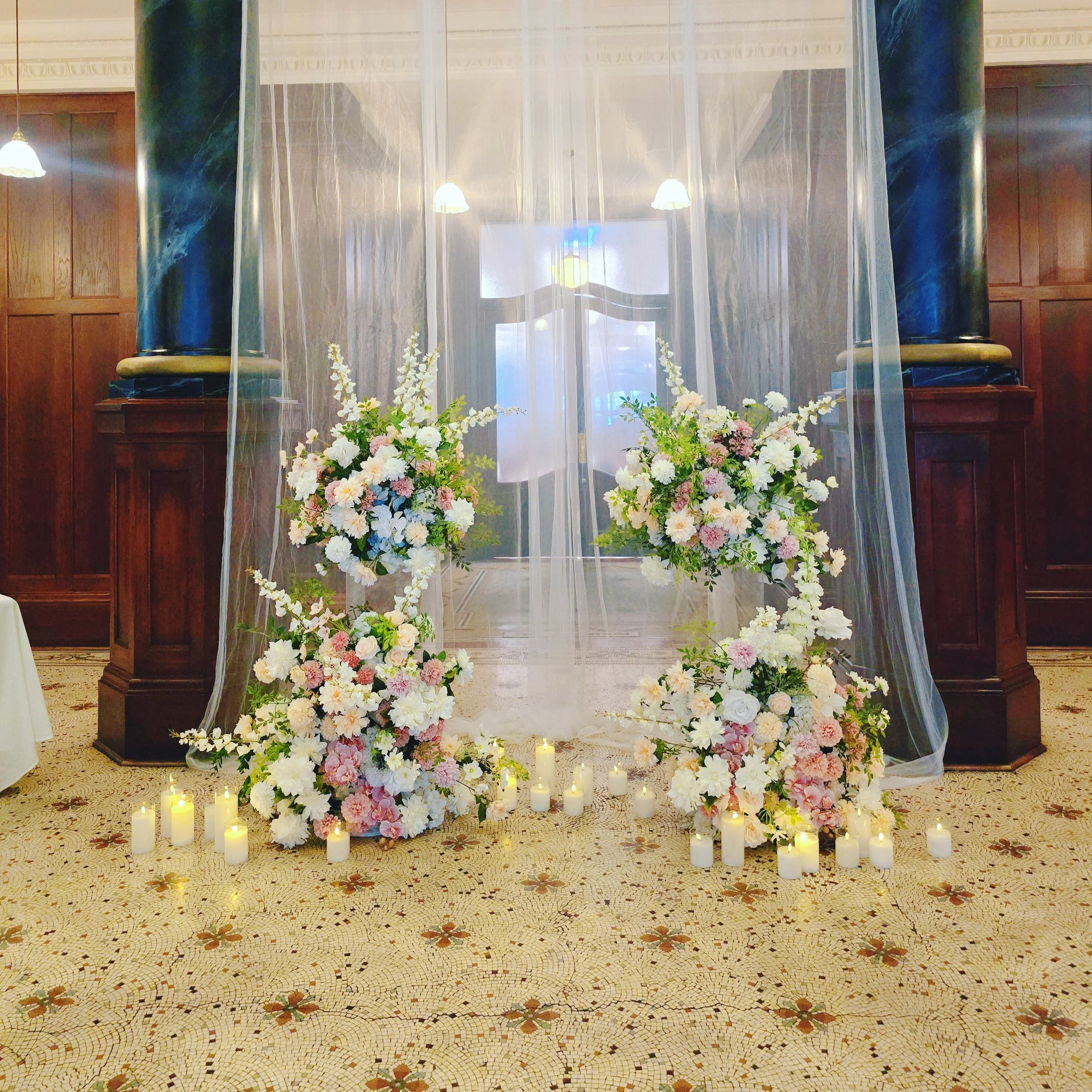 Flowing sheer drapes, glowing candles and garden florals created the perfect backdrop for an intimate &ldquo;I do&rdquo; moment beneath the grand architecture of this beautiful venue @rendezvousmelbourne

The pastel blooms paired with soft candleligh