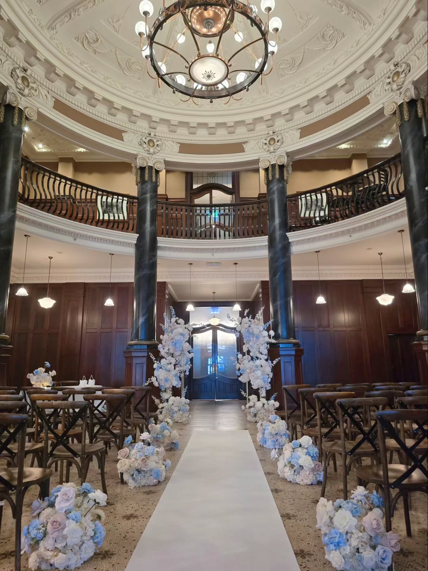 Romantic pastel blooms creating a beautiful contrast against the venue&rsquo;s charming heritage architecture. 🩵🤍✨