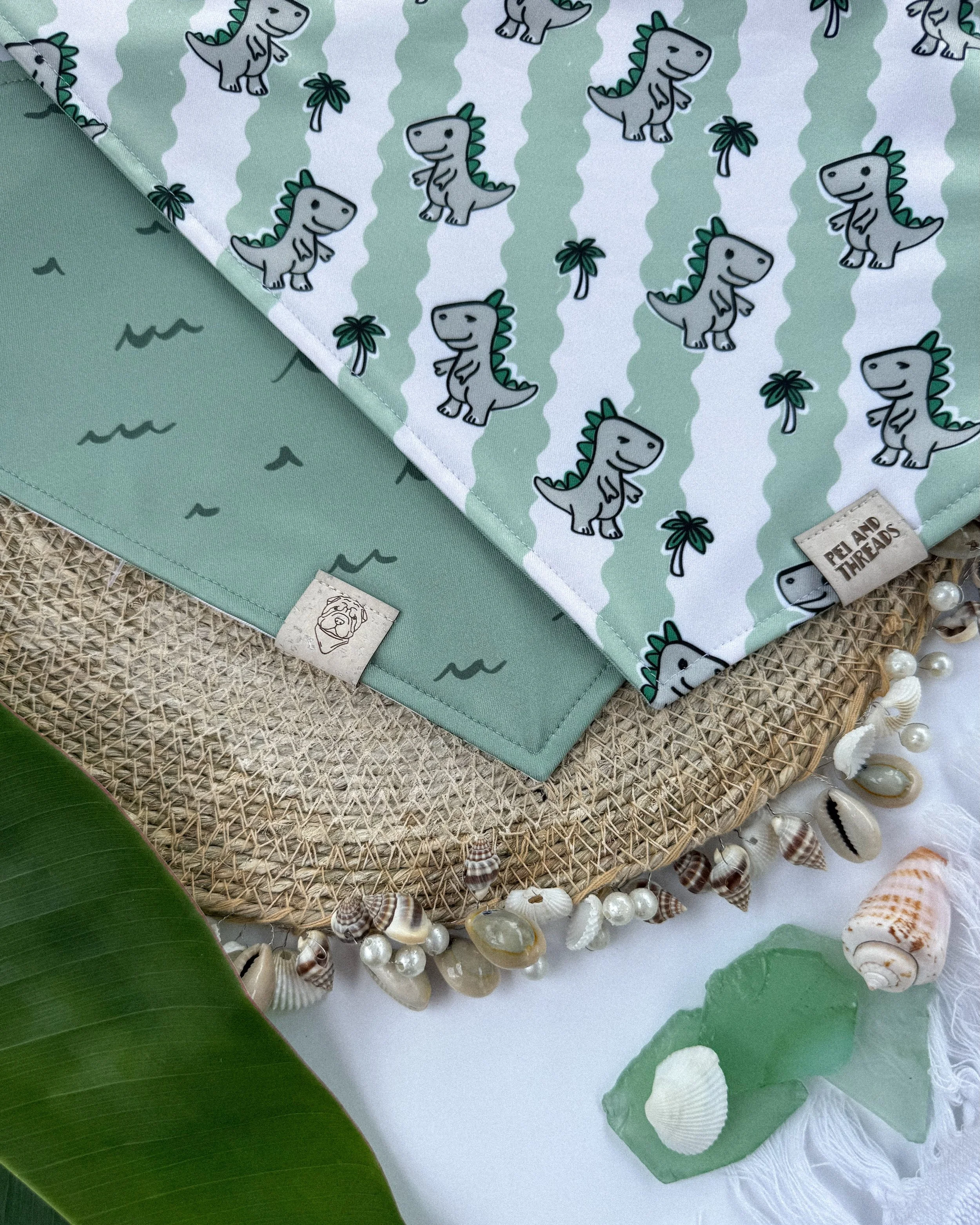This is Sandy Saurus 🦖🌴
The cutest beach dino you&rsquo;ll see this summer! All of our bandanas are reversible, so you get two looks in one.

Made with our premium Element Proof fabric, built for beach days, messy adventures, and everything in betw