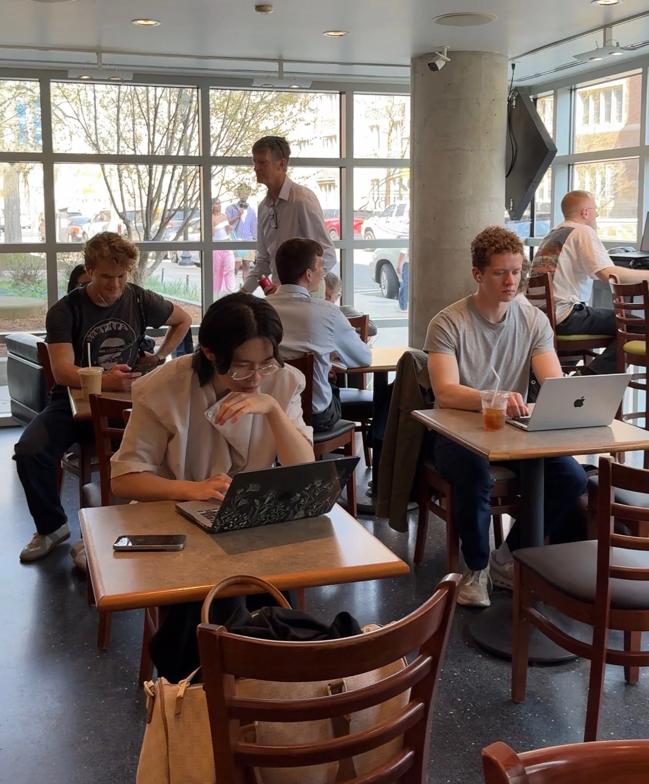 Customers working on laptops at communal tables inside Willoughby's Coffee & Tea in downtown New Haven