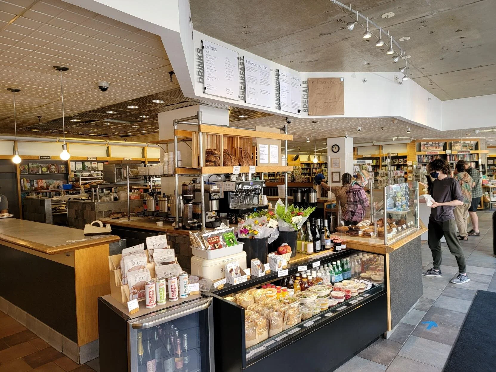 Cozy interior of Atticus Bookstore Café in New Haven, with bookshelves, and pastries on display