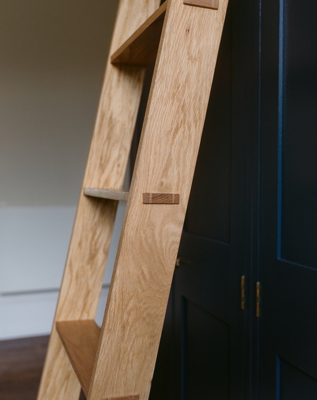 The star of the show here really is this ladder. Custom made in our workshop with solid oak using traditional carpentry techniques, our ladders can be added to any wardrobe with top boxes. Swipe to see how they are stored on the side of the wardrobe 