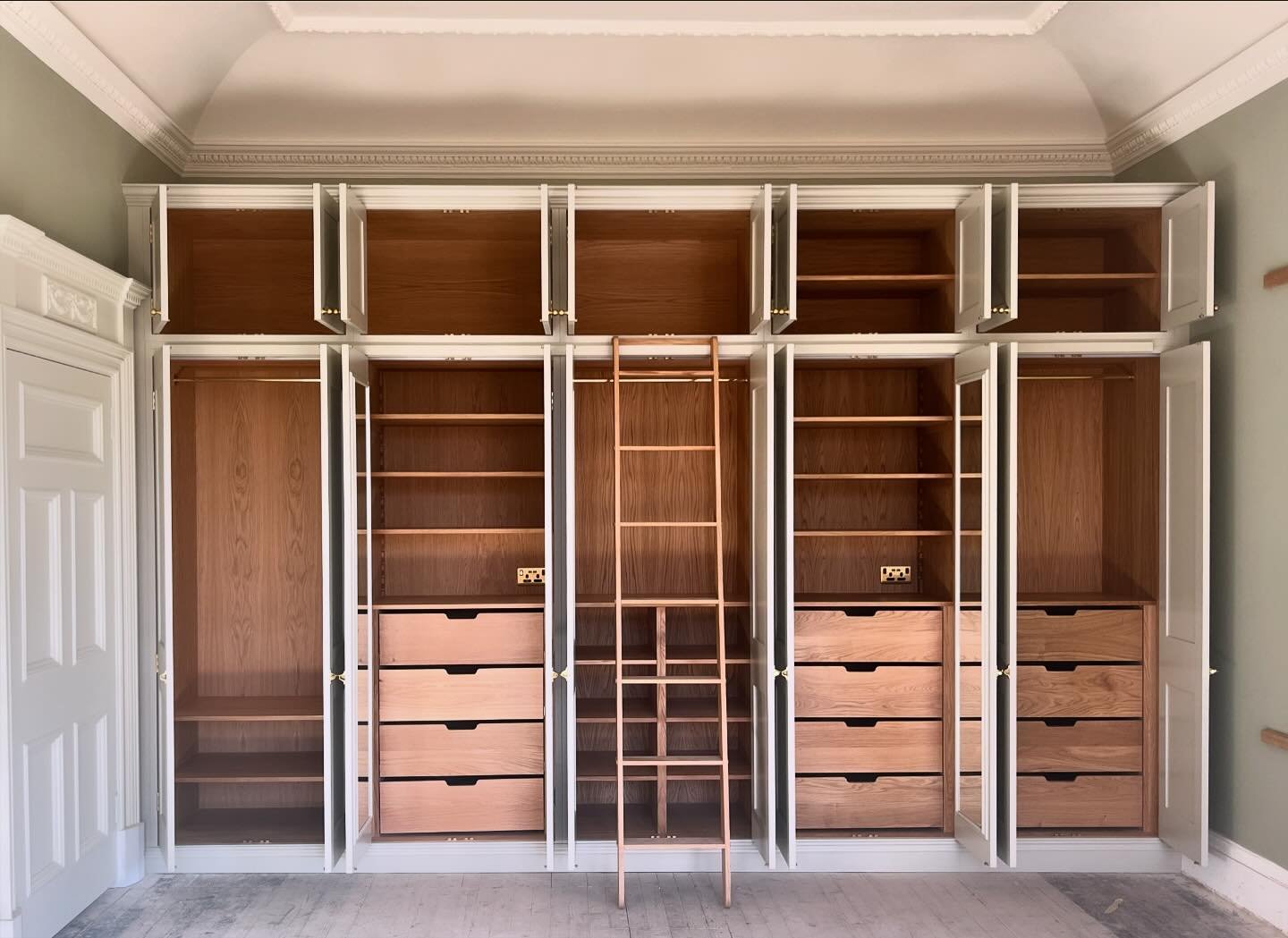 It was a privilege to work in this historic home, where a wall to wall run of wardrobes enhances the sense of scale and grandeur in the principal bedroom suite. The paint colour is &lsquo;Drop Cloth&rsquo; by Farrow &amp; Ball, with brass ironmongery