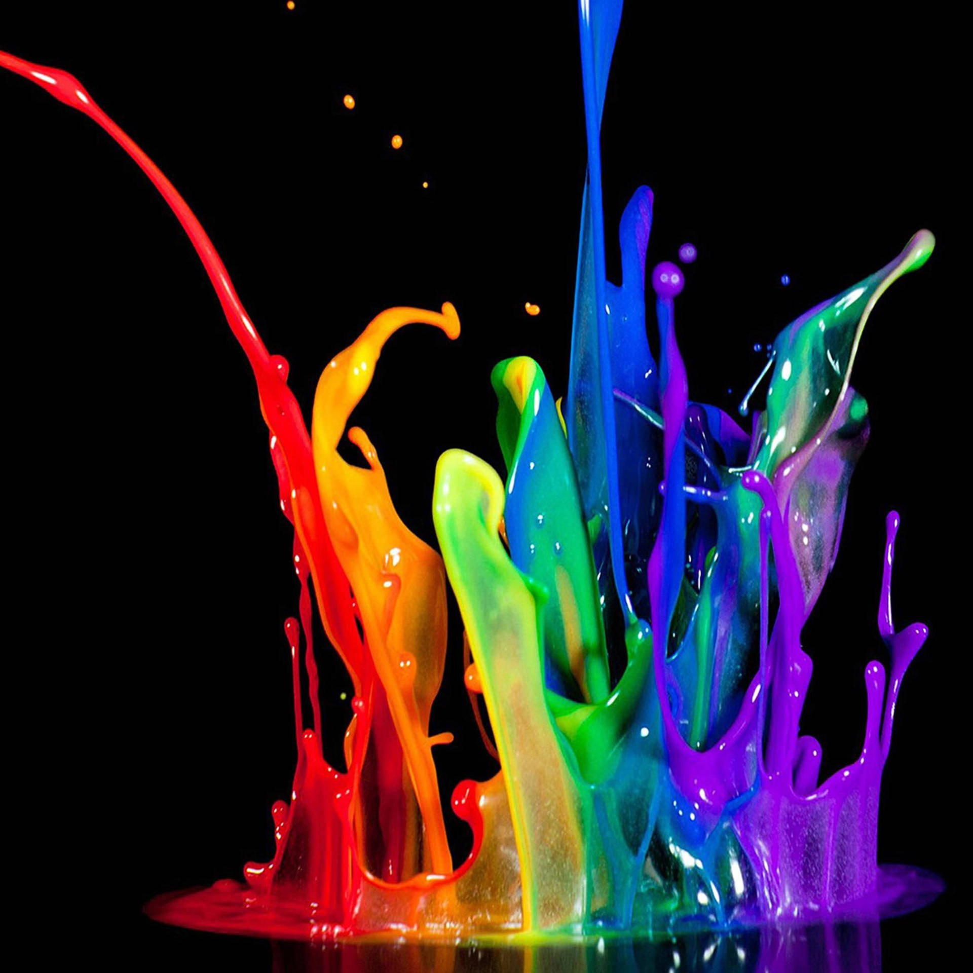 Colorful splashes of paint in red, orange, yellow, green, blue, purple, and violet on a black background.