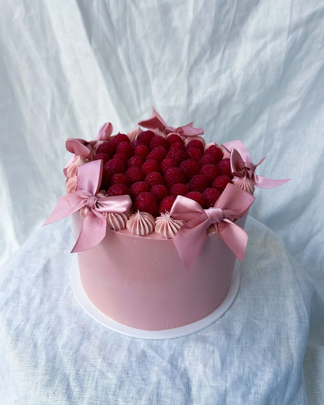 Dressed in pink bows and crowned with raspberries! 

This cake is basically ready for the ball, dancing the night away with a coupe of Champagne!🎀🍰

Perfect for anyone who likes their desserts with a little drama and anyone for who everyday is a sp