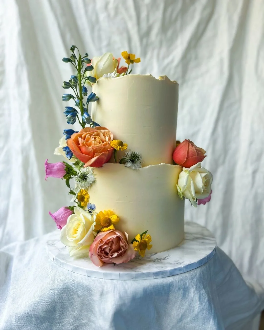 This colourful wedding cake, with bright spring blooms on a soft cream base, was such a joy to create for S&amp;J. Serving it at the stunning Hortus Botanicus alongside the kindest team, truly a pleasure!

Congratulations S&amp;J, thank you for your 