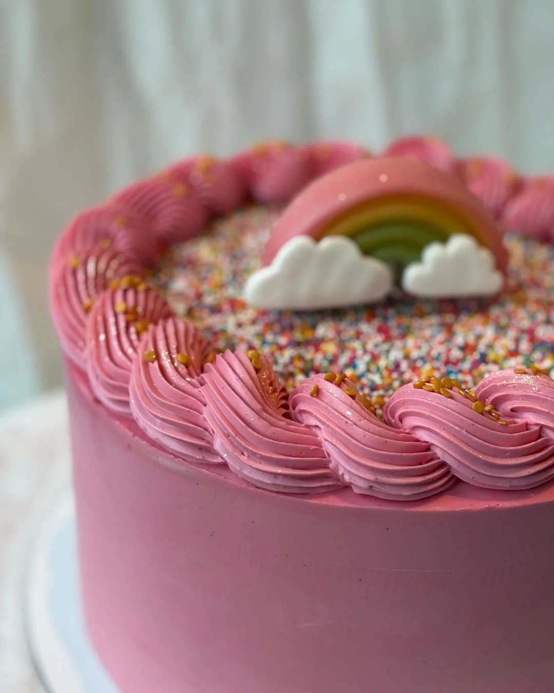 And than this hot pink one! Inspired by colorful adventures along the way. I'll try and share some of the trip in my stories. 

This hot pink cake, topped with playful sprinkles and a rainbow, reflects the joy and energy of travel. (And is also every