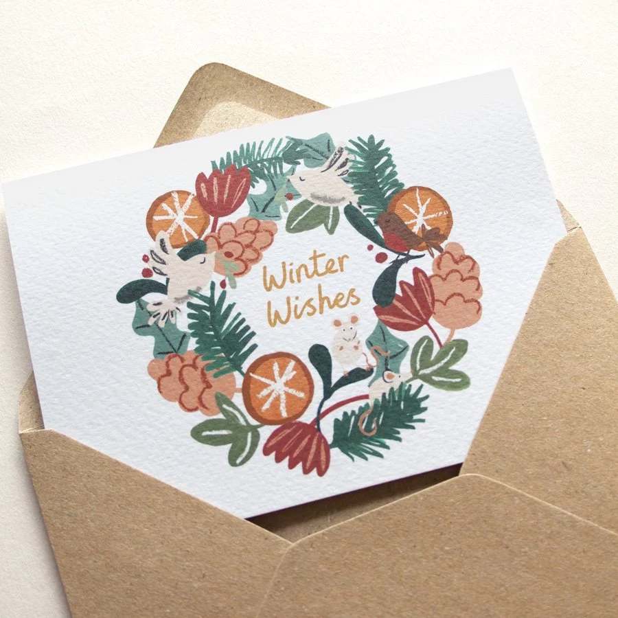 Winter Wishes Woodland Wreath Card on angle in kraft envelope