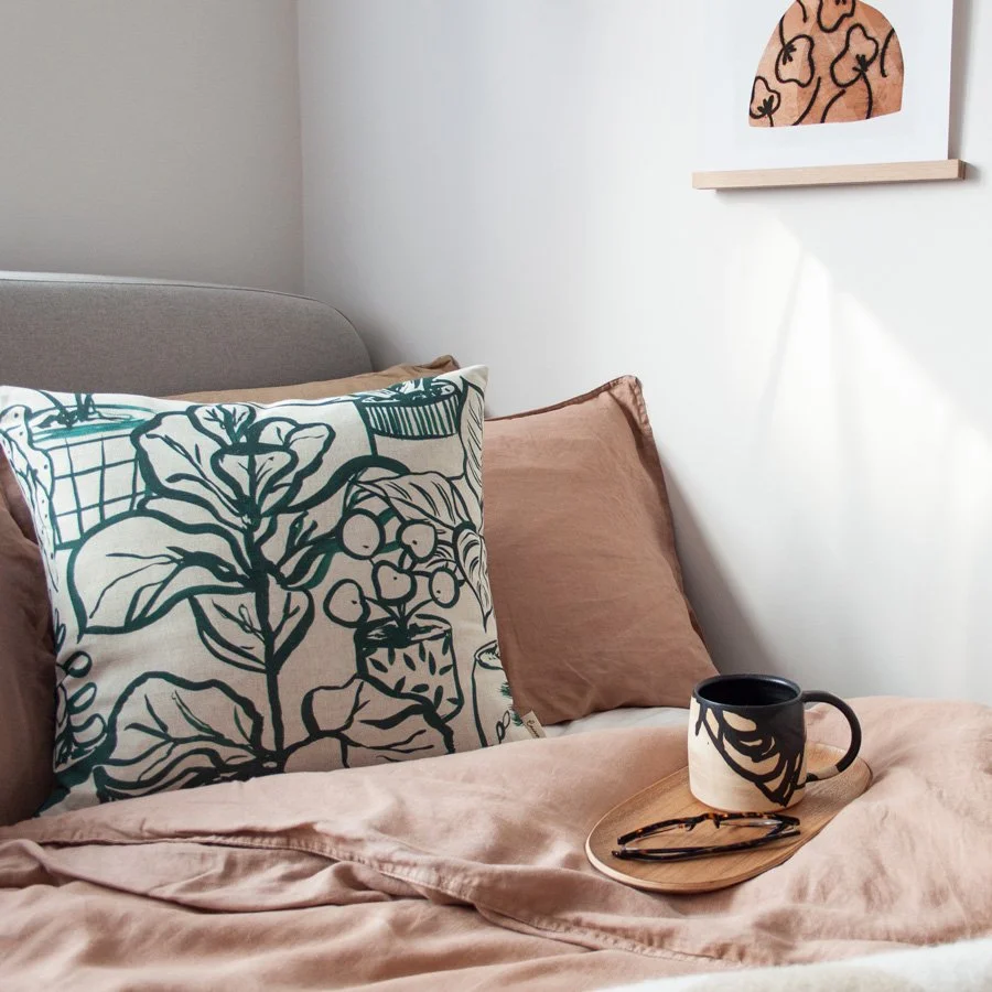 Houseplants Natural / Green Fabric as a cushion styled on linen bedding
