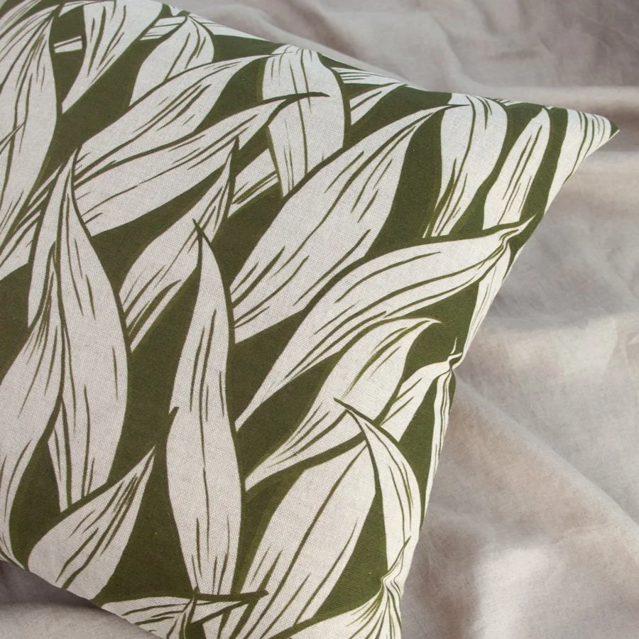 Wild Garlic Olive Green Fabric as a cushion styled on natural linen