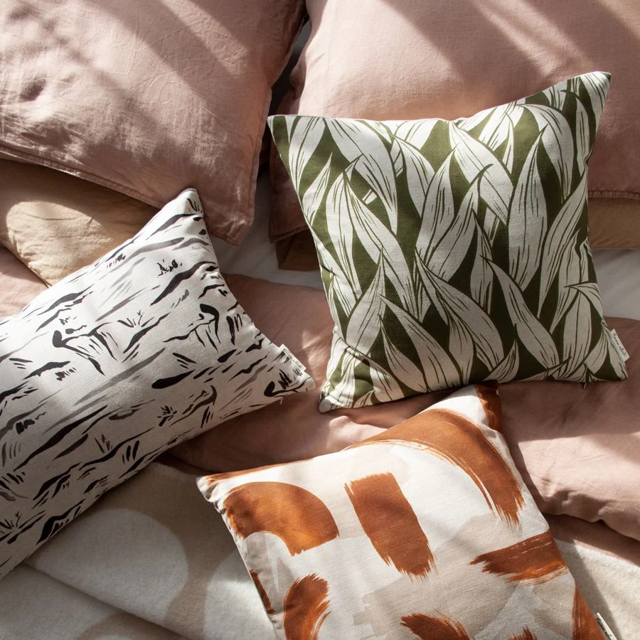 Wild Garlic Olive Green Fabric styled amongst other Emma Alviti patterned cushions