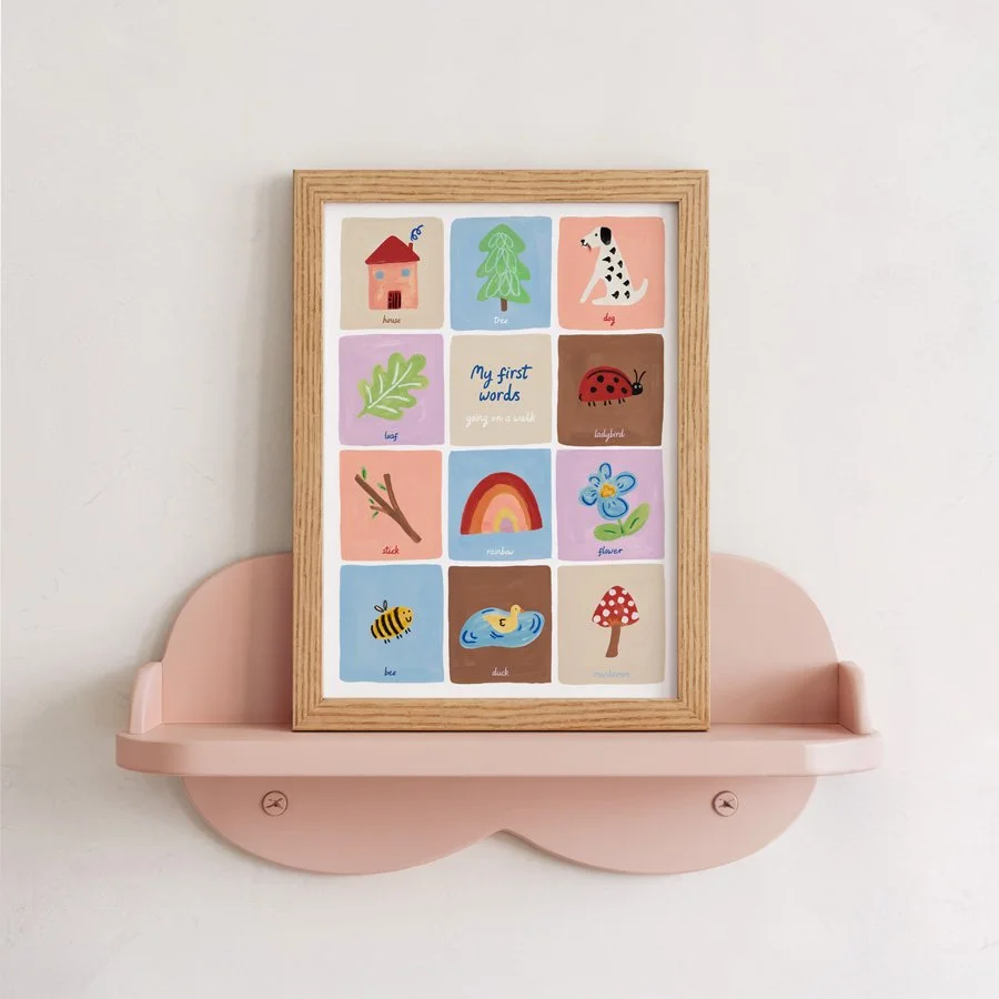 Little Em First Words Nursery Print in wooden frame on pink scalloped shelf